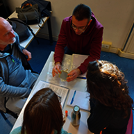 Image taken from above around people who are discussing around writings