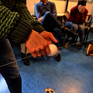 Practice phase of the workshop: close-up on hands touching a string